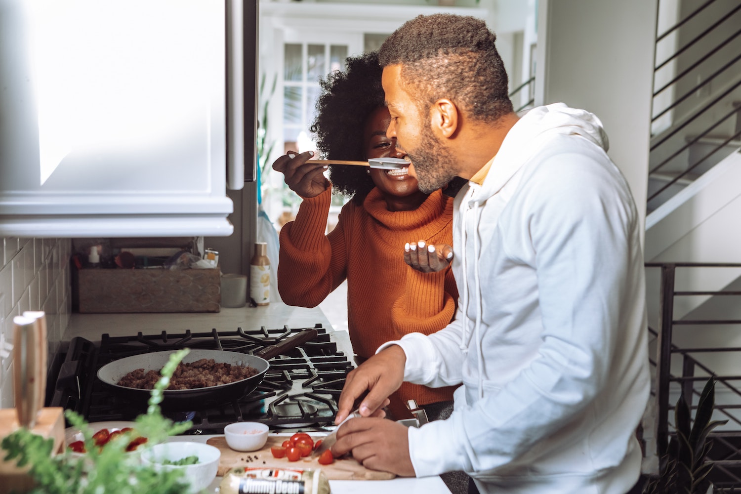 A father and child tasting a recipe together