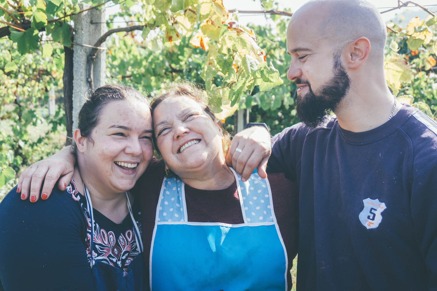 Three relatives laughing together outdoors